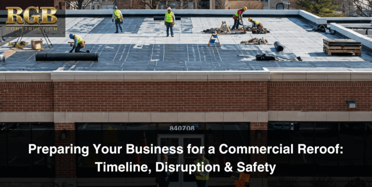Roofers conduct commercial roof replacement preparation while standing on a flat roof